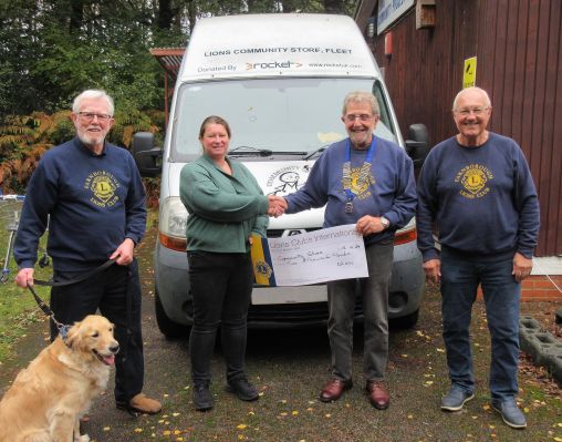 Lions President Chris Seabrook presents a cheque for £2,000 to Nichola Painter - Manager at the Lions Community Store