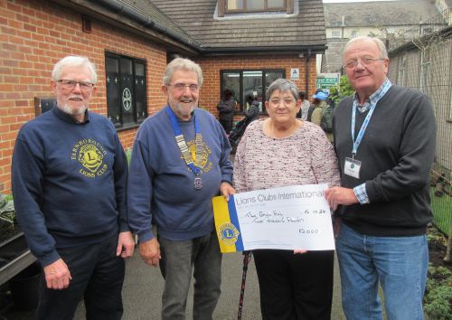 Lion Carole Hambleton presents a cheque for £1,000 to Simon Gordell at the Aldershot Grub Hub.