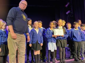 Grange School being presented their certificate by Lion President Steve Boast