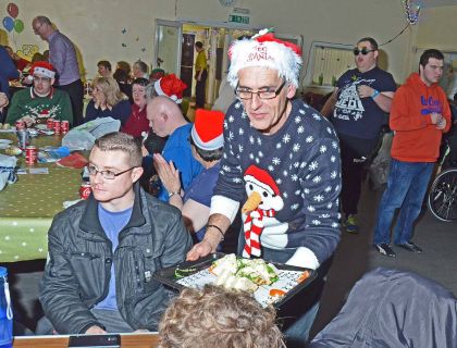 Ian Hambleton from Aldershot Lions helps serve refreshments spread at the Parkside Christmas Party Parkside C