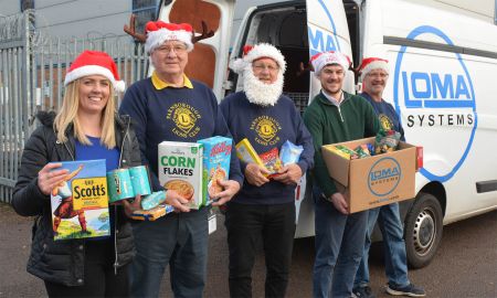 Staff from Loma Systems in Farnborough and the Lions load up food donations bound for the Lions Community Store for onward distribution to families in need at Christmas