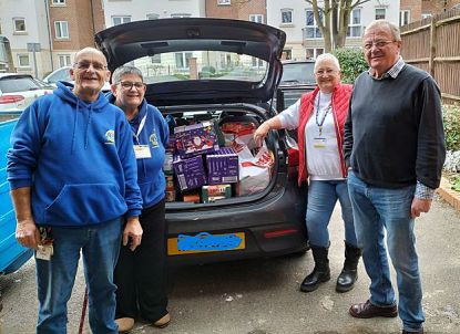 Aldershot Lions delivering donations to the Grub Hub Foodbanks pictured with Grub Hub Manager Simon Gornall.